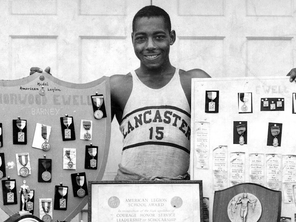 Barney Ewell with his medals on display